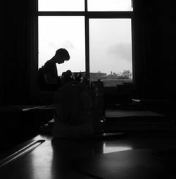 Silhouette of statue on window