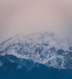 Scenic view of snowcapped mountains against clear sky