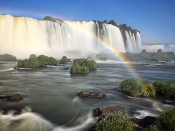 Scenic view of waterfall against sky