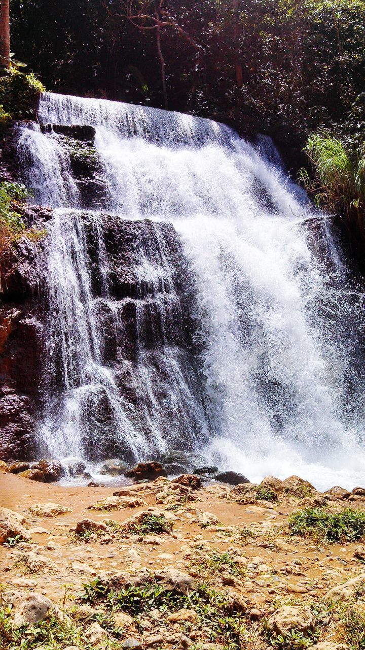 SCENIC VIEW OF WATERFALL IN FOREST DURING RAINY SEASON