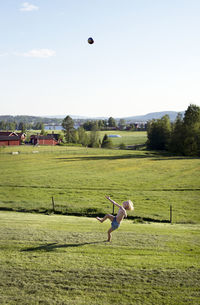 Boy playing ball on grass