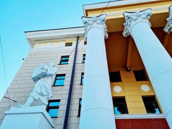 Low angle view of statue against building