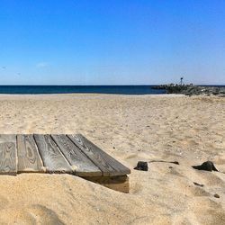 Scenic view of beach against blue sky