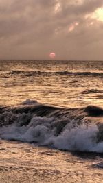 Scenic view of sea against cloudy sky