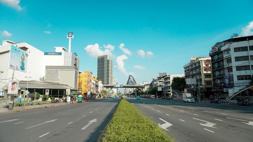 View of city street and buildings against sky