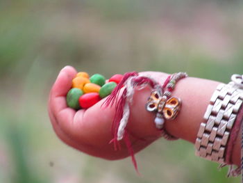 Close-up of woman hand holding multi colored candies