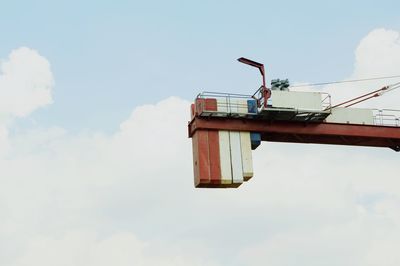 Low angle view of crane against sky