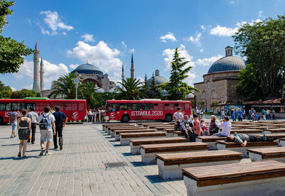 Group of people outside temple against buildings