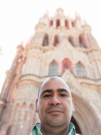 Low angle portrait of mature man against historic building