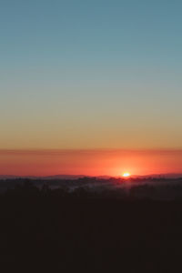 Scenic view of silhouette landscape against clear sky during sunset