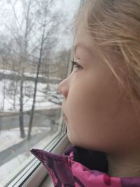 Close-up portrait of a girl in snow