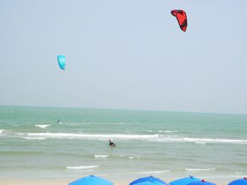 People paragliding at beach