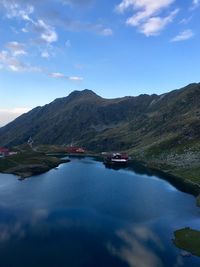 Scenic view of lake and mountains against sky