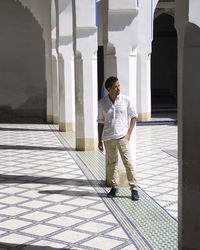 Full length of young man looking at building