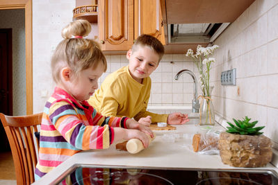 Mother and daughter in kitchen at home