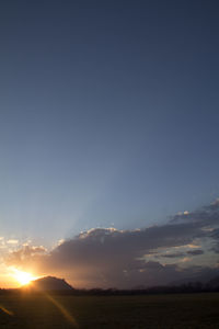 Scenic view of field against sky during sunset