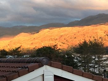 Scenic view of mountains against cloudy sky