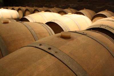 Close-up of wine barrels in cellar