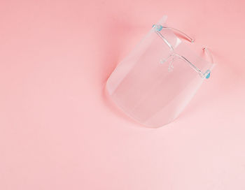 Low angle view of pink balloons against wall