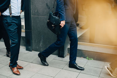 Low section of man walking on footpath