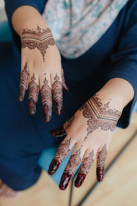Low section of woman with henna tattoo