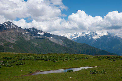 Scenic view of snowcapped mountains against sky