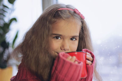 Portrait of cute girl drinking hot chocolate