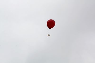 Low angle view of balloons against sky