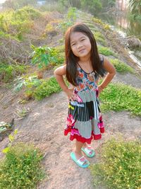 Portrait of smiling girl standing against plants