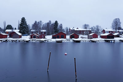 Houses and buildings against sky during winter