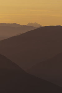 Scenic view of silhouette mountains against sky during sunset