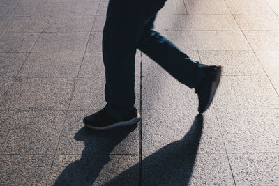 Low section of person walking on footpath