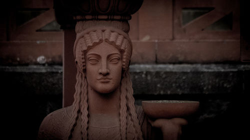 Close-up of angel statue against building