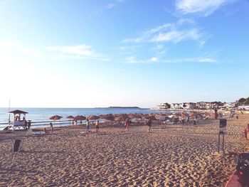 People on beach against sky