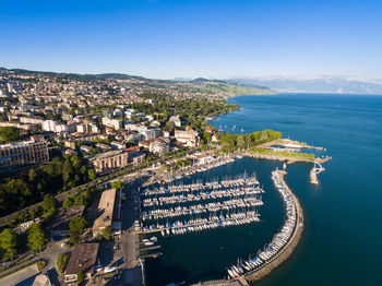 High angle view of townscape by sea against sky