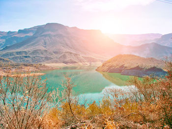 Scenic view of lake and mountains against sky