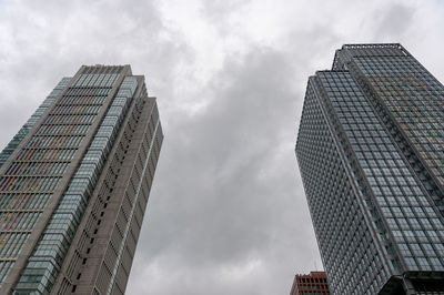 Low angle view of modern buildings against sky in city