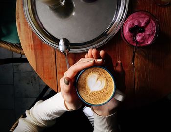 High angle view of woman holding coffee cup