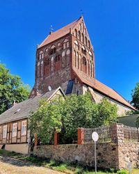 Low angle view of old building against clear blue sky