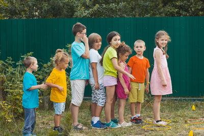 Full length portrait of friends standing outdoors