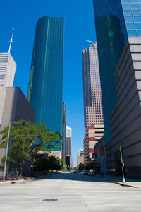 Modern buildings in city against clear sky