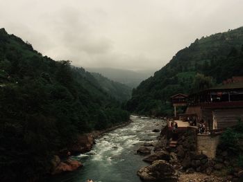 High angle view of river amidst mountains against sky