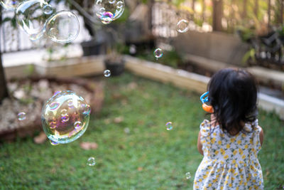 Rear view of woman in bubbles