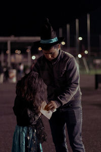 Portrait of a girl with her father getting ready for halloween celebration.