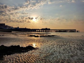 Scenic view of beach against sky during sunset