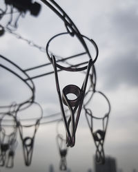 Low angle view of spiral metal against sky