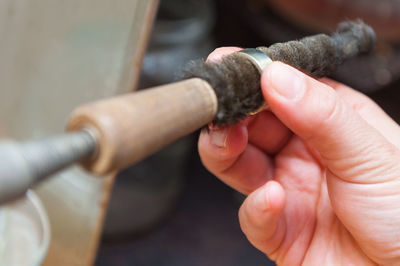 Close-up of hand holding cigarette