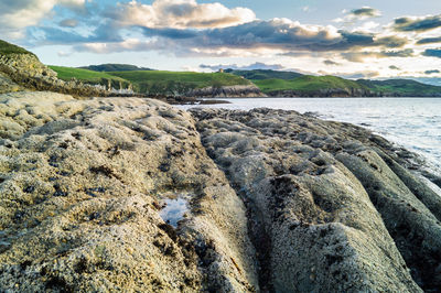 Rocks on beach against sky