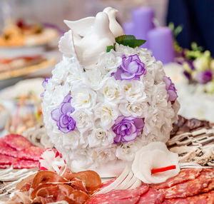 Close-up of food by flower decoration on table