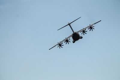 Low angle view of airplane against clear sky